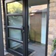 Front and Entrance Doors with black frame at APS Double Glazing