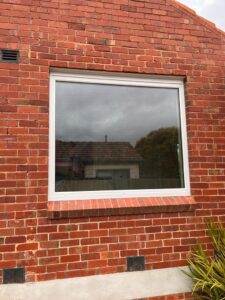 awning-windows-in-white-UPVC-installed-with-double-glazed-panels-that-have-Low-E-coating-to-improve-energy-sound-efficiency
